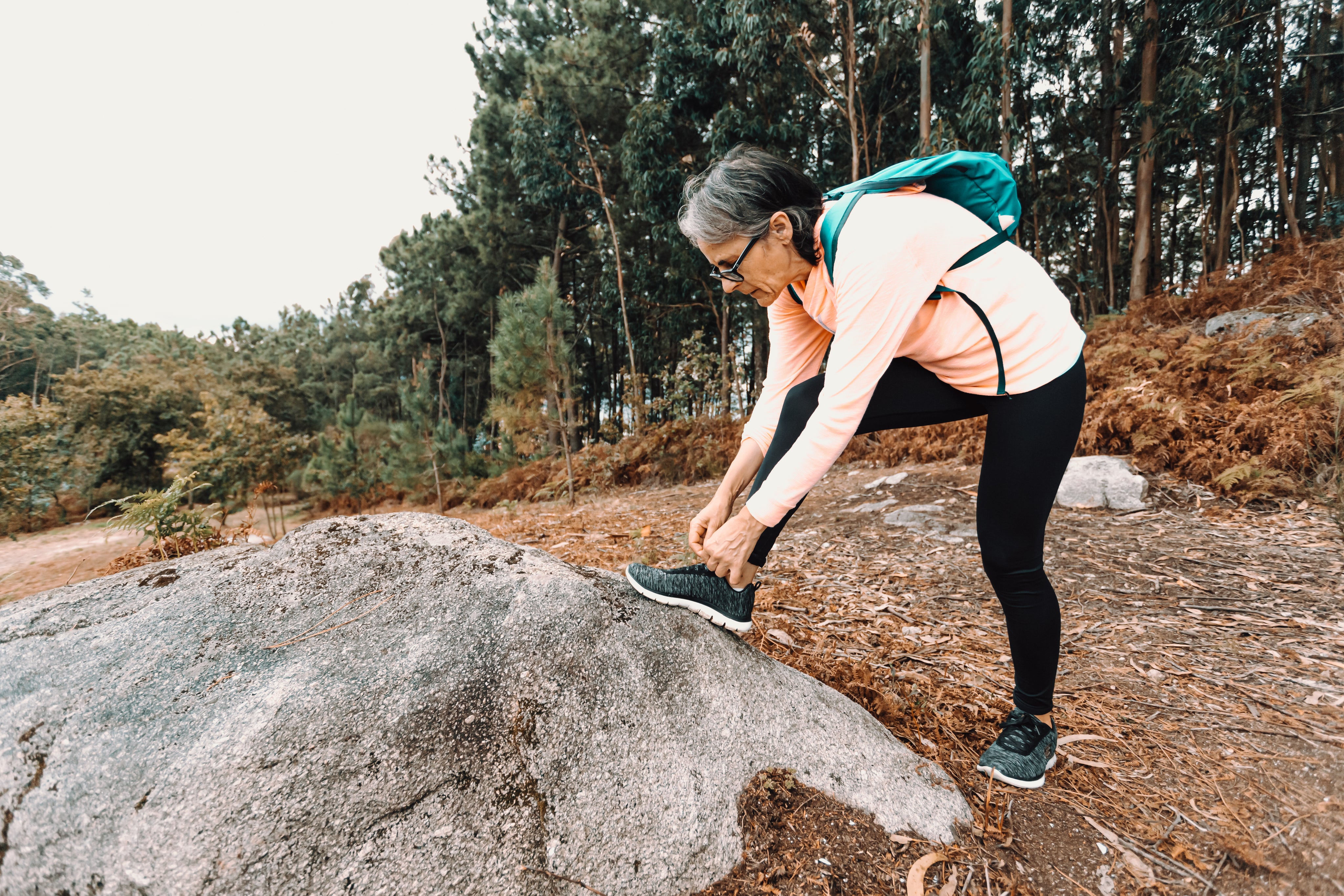 files/woman-stops-on-a-hike-to-tie-their-shoe.jpg